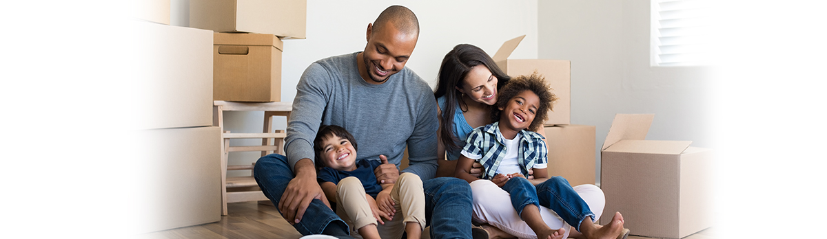 Family in house surrounded by moving boxes